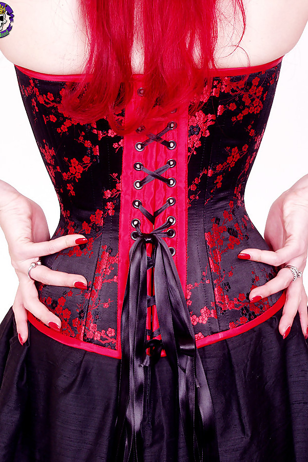 Yolanda corset-clad hottie with cherry red hair