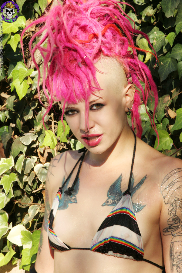 pink haired tattooed punk girl by the pool